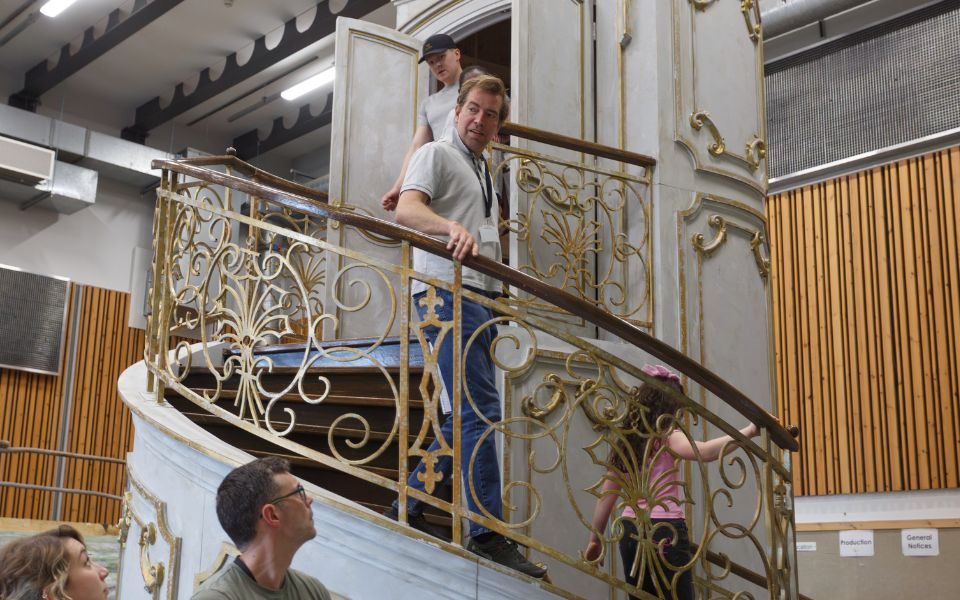Edward Bennett walking down an ornate spiral staircase in rehearsals for The Sound of Music.