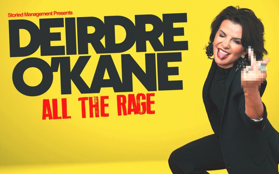 In an all-black outfit, Deirdre O'Kane winks and sticks her tongue out, holding up a pixelated hand gesture. Text reads: Storied Management presents Deirdre O'Kane: All the Rage.