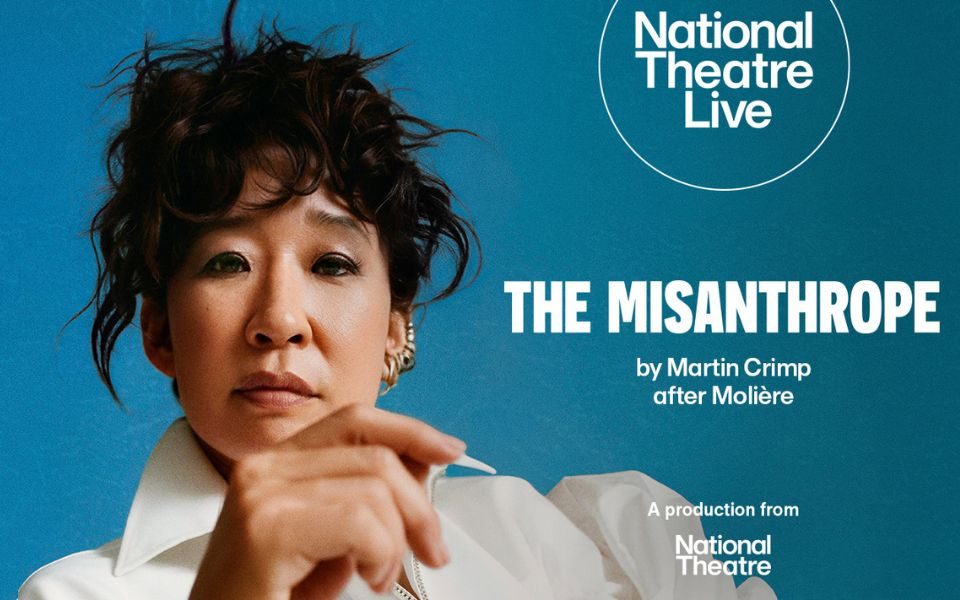 In front of a blue background, a woman with a messy up-do and white shirt looks at the camera, with a hand casually raised in front of her. Text reads: National Theatre Live. The Misanthrope by Martin Crimp after Moliere. A production from National Theatre.