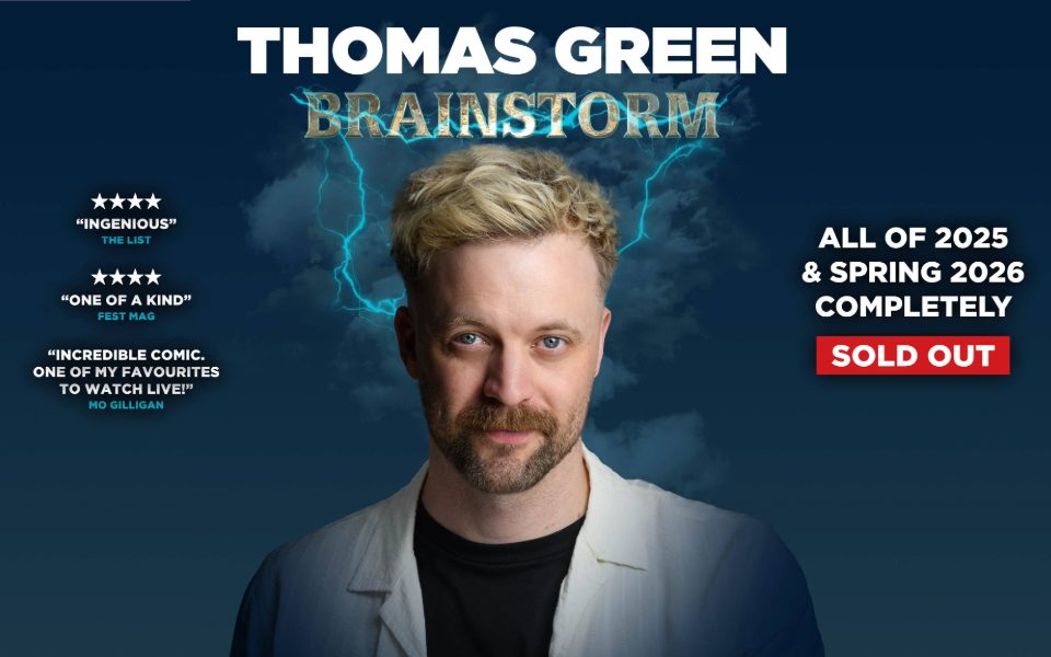 Headshot of Thomas Green wearing a black t-shirt under a pale cream light shirt stood against a smoky backdrop with blue bolts of electricity circling around his head. Text reads: Thomas Green: Brainstorm. 4 stars. 