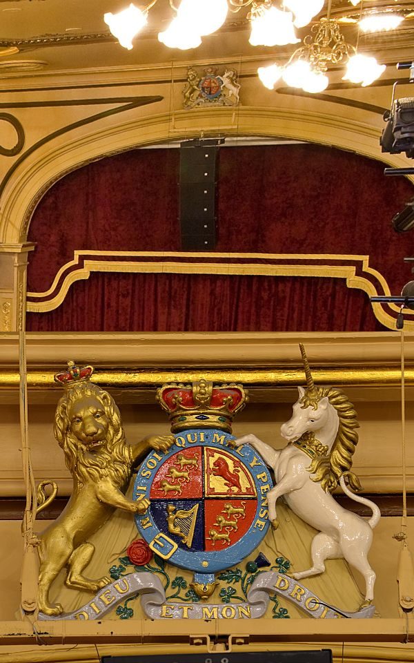 Two images showing a royal crest above the stage at City Varieties Music Hall