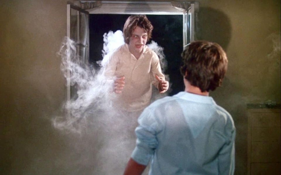A spectral child with white eyes floats through a window in a cloud of smoke, as another character watches on in the foreground.