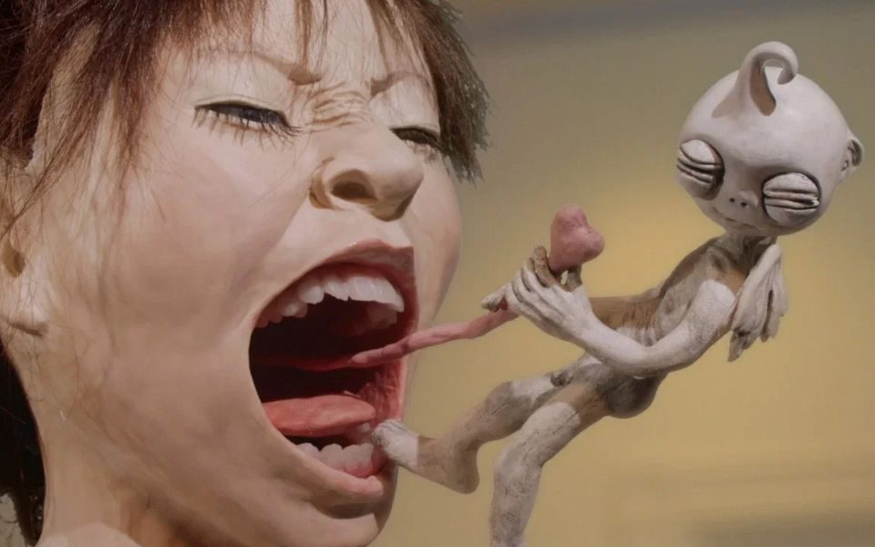 In claymation style, a woman screams as a small winged creature pulls her tonsils.